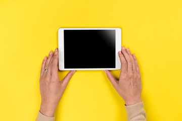 Closeup shot of  Woman's hands with perfect manicure  holding tablet, Empty display device. with clipping path
