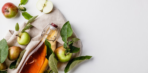 Apple cider vinegar and fresh apples, flat lay, space for your text