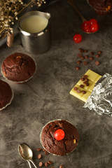 Chocolate muffins on dark background. Milk and chocolate.