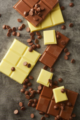 White and milk chocolate isolated. Top view of various chocolate bars with copy space.