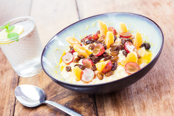 Tasty breakfast idea - porridge with fresh fruit and honey