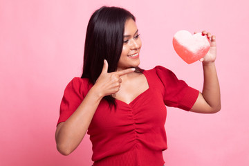 Asian woman point to red heart.