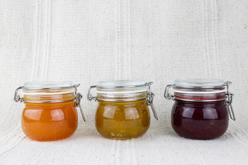 Composition of jars full of delicious sweet jam, healthy fruit marmalade, horizontal