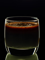 panakota in a glass cup on a black background..