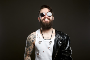 smiling man. bearded Sexy boy in leather coat
