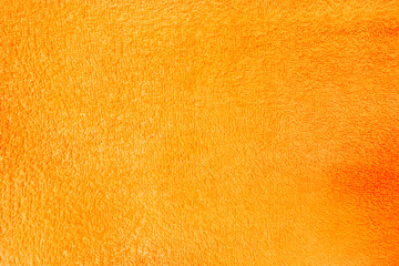 The surface of the orange terry towel. Closeup Texture background