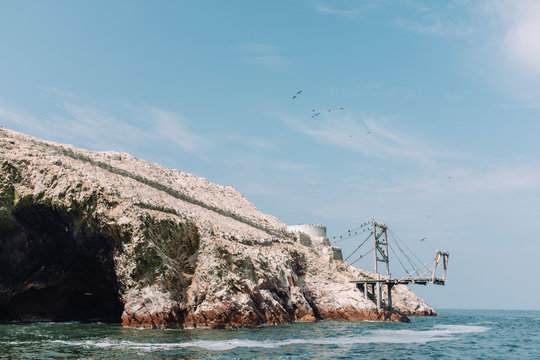 Pulled back view of old pier in Ballestas Islands, Peru