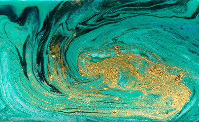 Green and gold marbling pattern. Golden powder marble liquid texture.