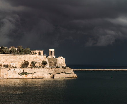 A storm passes by the harbor of Valleta, Malta.