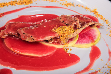 closeup tasty meat slices served under red sauces and spices