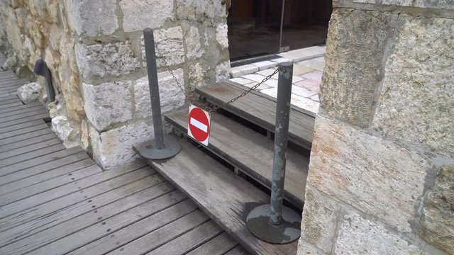 stop sign and passage prohibited dangling in the wind in the old city of Jerusalem