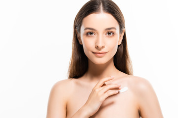 Obraz na płótnie Canvas beautiful naked woman with perfect skin applying cosmetic cream on skin isolated on white