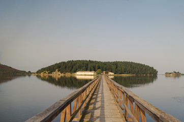 Obraz premium Wooden pedestrian bridge to island Zvernec inside Narta Lagoon. On island there is St. Mary's Monastery, also known as Monastery of Dormition of Theotokos Mary, is medieval Byzantine church. Albania