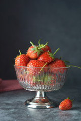 Fresh juicy strawberries in glass bowl. Summer, natural berry from garden.