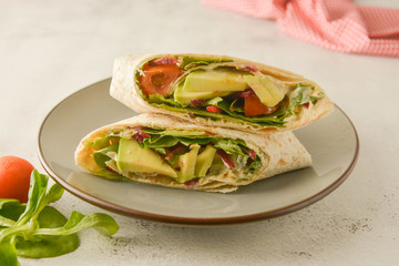 Wraps or torttila. Avocado, vegan wrap sandwiches. Healthy food.