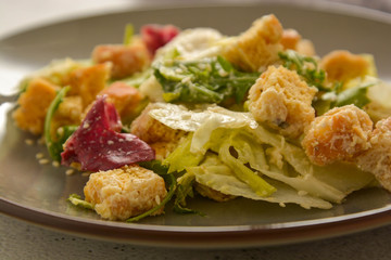 Close up caesar salad with croutons and dressing. Healthy foods.