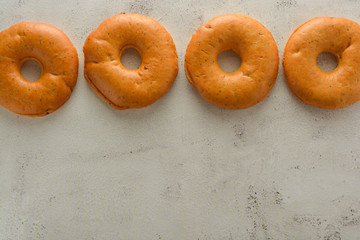 Bagels isolated on bright, textured board. Copy space