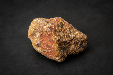 Partly metamorphic rock containing red, yellow and white components