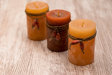 Romantic and scented candles on old wooden background