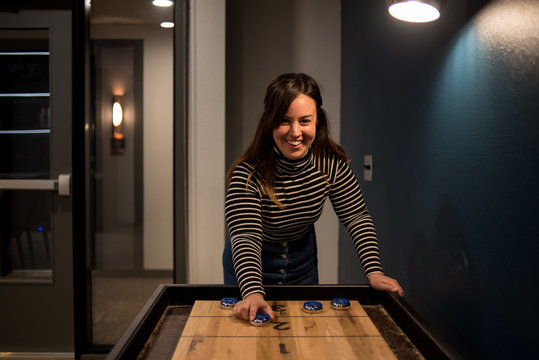 Happy Woman Playing Shuffleboard Game