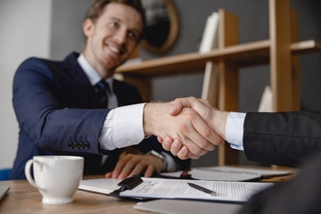 Two businessmen shaking hands after making a deal