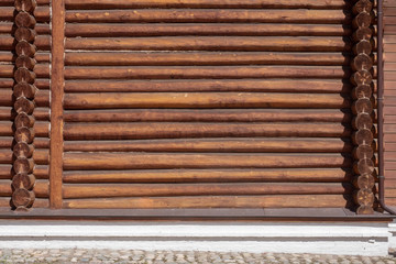 Background, wall of a wooden house made of logs.