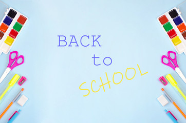 Fototapeta na wymiar Back to school banner with stationery and blue background.