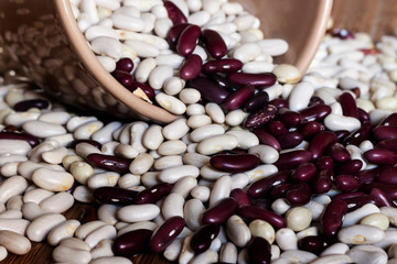 Red and white bean background sprinkled from bowl. Vegetable protein. Veggie tables concept