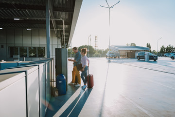 Couple using parking payment machine in airport