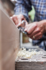  Close up of male hands doing woodwork using tools