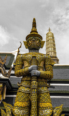 Fototapeta premium Beautiful close up color black white and gold Wat Phra Kaew or Temple of Emerald Buddha, Guardian statues pagoda and Grand palace located within the grounds of the Grand Palace in Bangkok