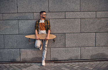 Bearded caucasian man with longboard