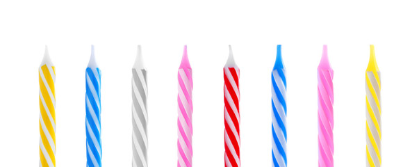 Set with different birthday candles on white background