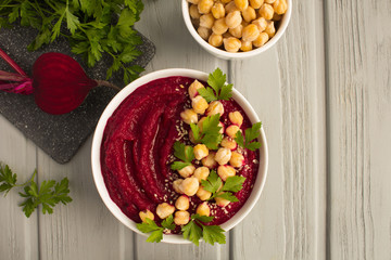 Vegan smoothies bowl with beetroot and chickpea on the grey wooden  background.Top view.Copy space.