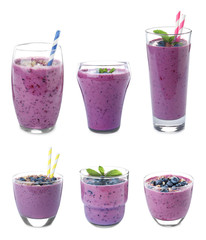 Glasses of delicious blueberry smoothie on white background