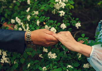 Fototapeta premium man gently holding hands of a woman in his hand
