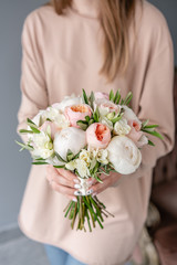 Obraz na płótnie Canvas Bridal bouquet with white. Beautiful bouquet of mixed flowers in woman hand. Floral shop concept . Handsome fresh bouquet. Flowers delivery