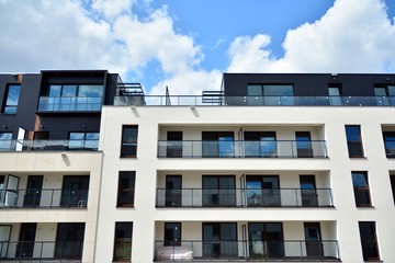 Multistory new modern apartment building. Stylish living block of flats.