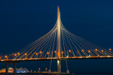 Bridge over the river at night on long exposure. Fragment of Cable-stayed bridge across the...