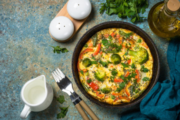 Frittata with fresh vegetables in the skillet.