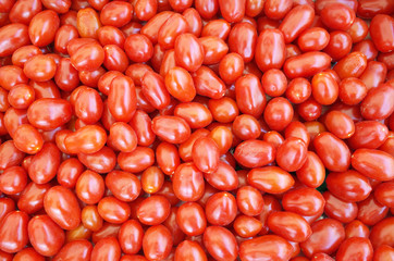 Top view vibrant red cherry tomatoes close up.