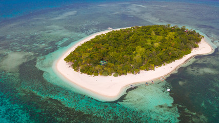 Mantigue Island, Philippines. Tropical island with white sandy beach and coral reefs. Seascape, view from above.