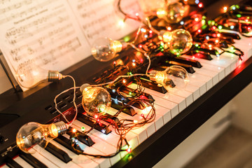 Piano keyboard with Christmas decoration, closeup