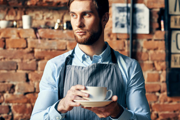 young man drinking coffee in cafe