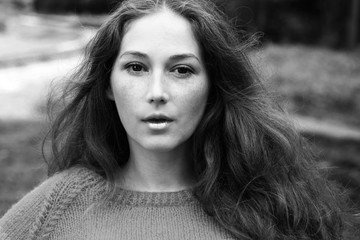 It is black a white portrait of the red woman with freckles