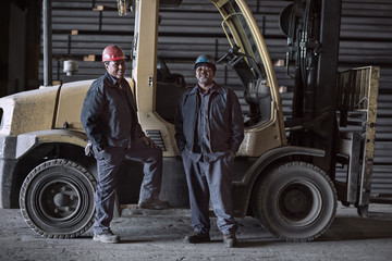 Portrait of factory workers on large forklift © Cavan for Adobe