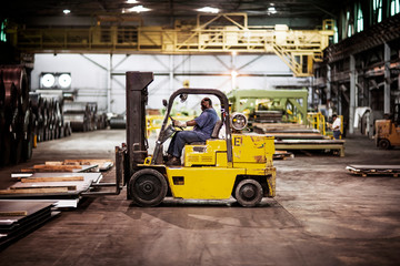 Man driving forklift in warehouse © Cavan for Adobe