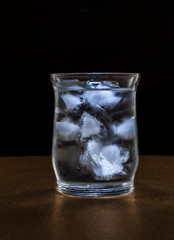 Ice water in a dark environment, as part of dark food photography or low key light photography