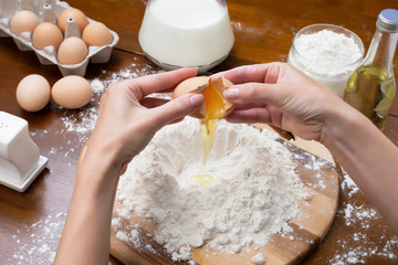 Making dough from eggs and milk. Cooking and home concept