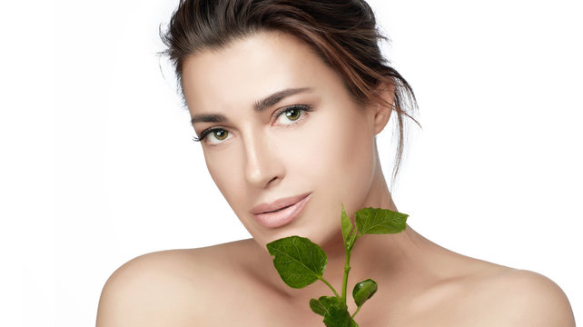 Natural beauty healthy skin woman face with fresh green leaves. Organic and bio skin care concept